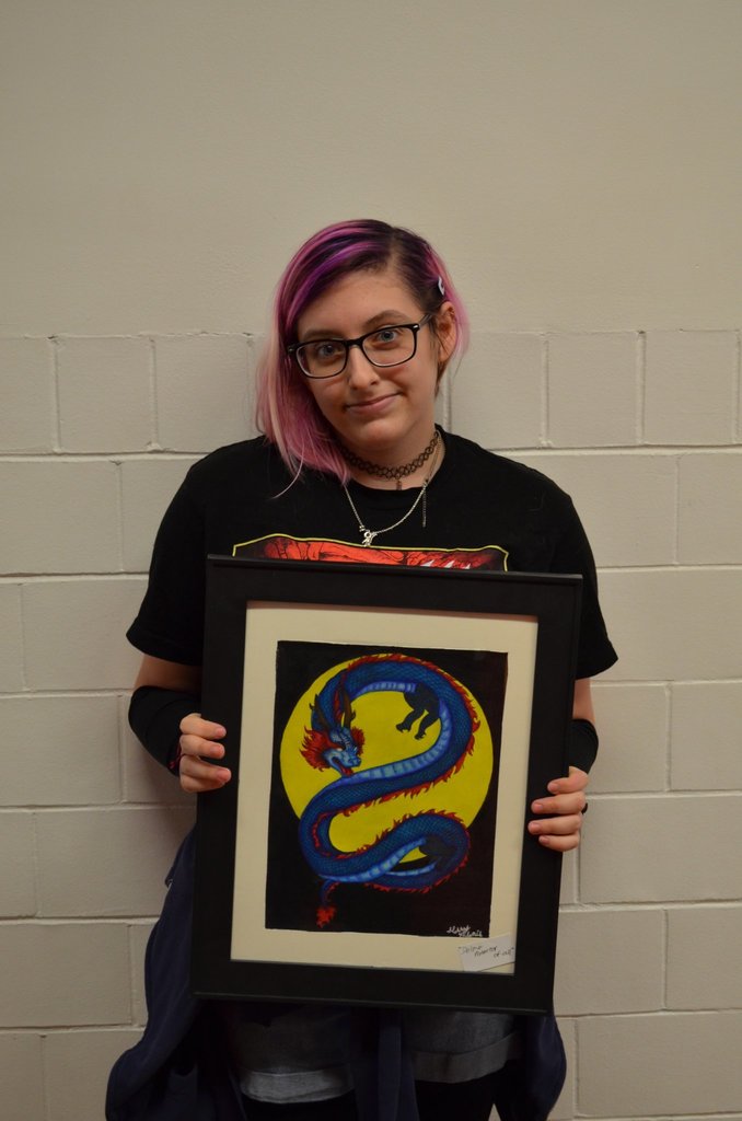 Art club student with artwork